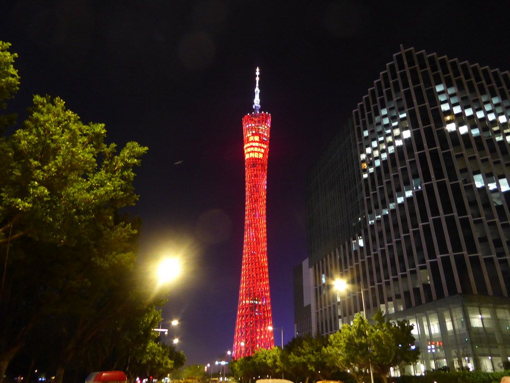 Canton Tower lit up at night over the Pearl River