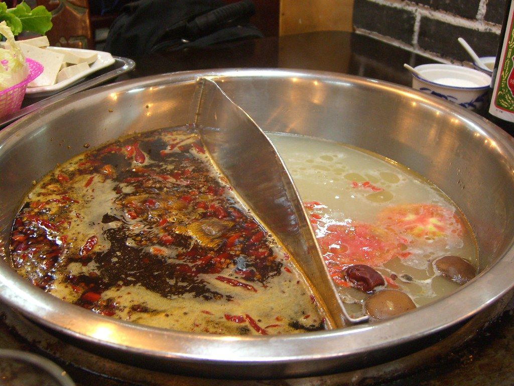 Spicy red oil Sichuan hotpot bubbling in a pot