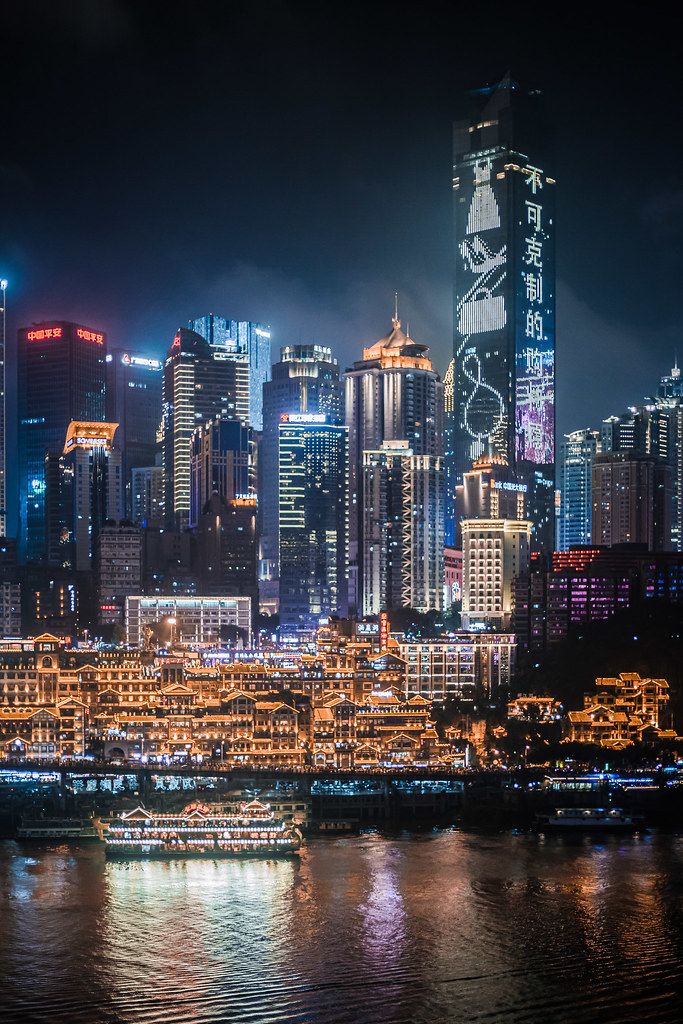 Chongqing cyberpunk skyline at night over the river