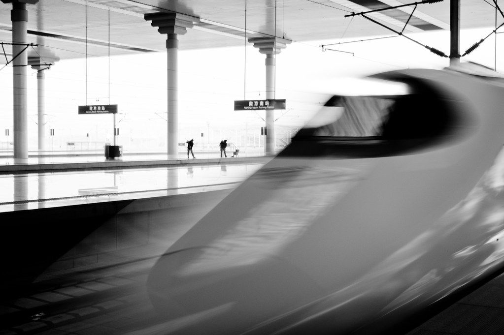 A sleek CRH high-speed train waiting at a Chinese station platform