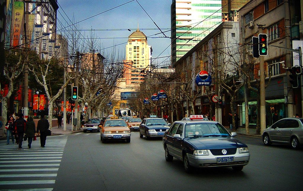 A DiDi ride-hailing car on a Chinese city street