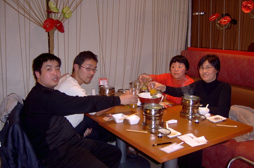 A celebratory toast with small glasses at a Chinese banquet
