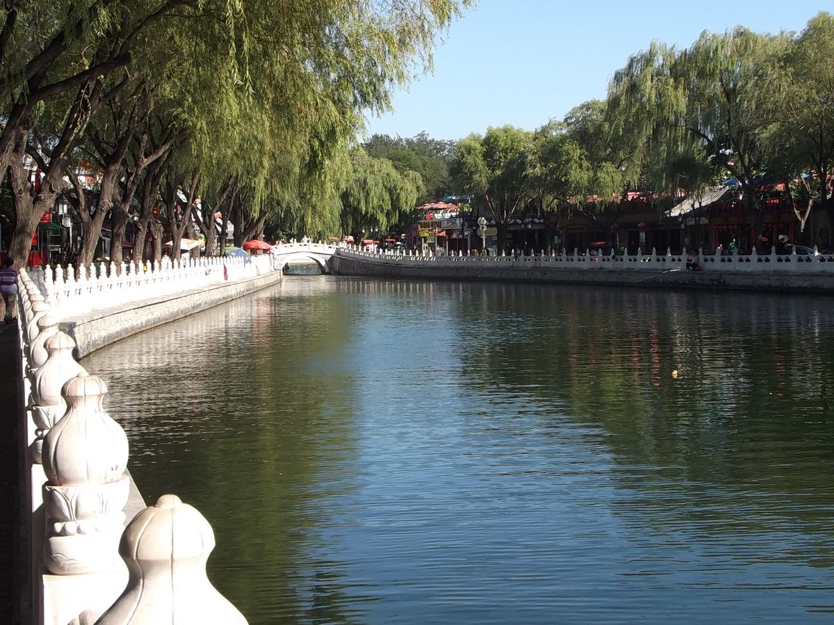 Houhai lake in Beijing at dusk with willows and boats
