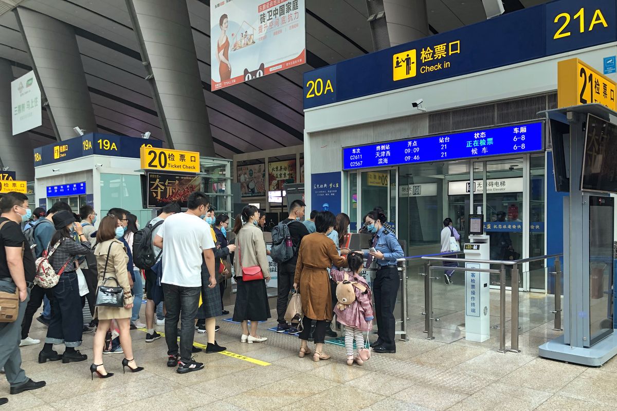 Bilingual Chinese-English signage and ticket gates inside a high-speed rail station