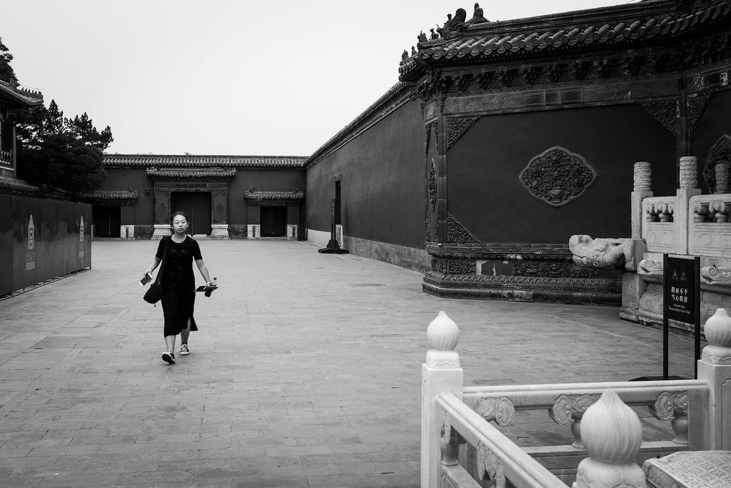 A solo woman traveler with a backpack in a Chinese city